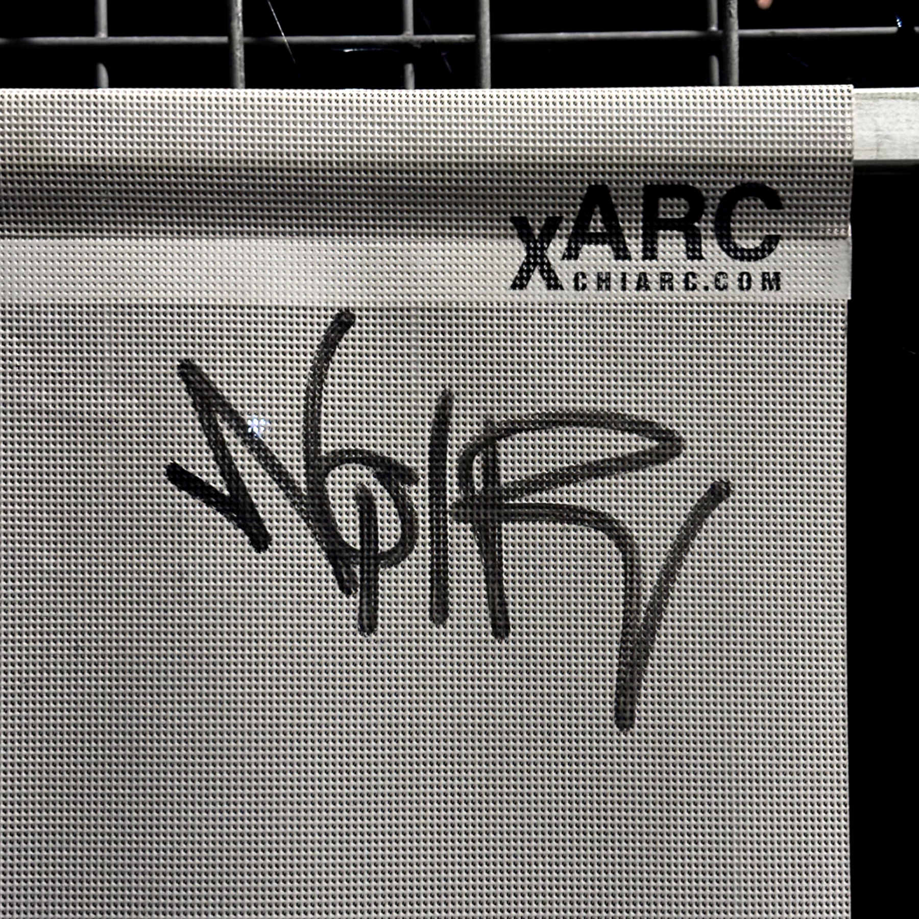 Graffito tag with the French word NOIR applied by unknown artist to a CHIARC construction site sign in the city of Meiningen.